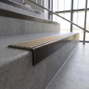 Solid brass stair nosing, 59.5mm tread with a 30mm square front, in Antique Bronze finish with Fawn Castellated insert, fitted to a staircase