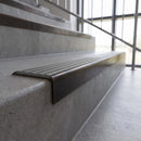 Solid brass stair nosing, 59.5mm tread with a 30mm square front, in Antique Bronze finish with Flint Castellated insert, fitted to a staircase