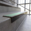 Solid brass stair nosing, 59.5mm tread with a 30mm square front, in Antique Bronze finish with Jade Castellated insert, fitted to a staircase