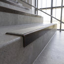 Solid brass stair nosing, 59.5mm tread with a 30mm square front, in Antique Bronze finish with Light Grey Smooth Textured insert, fitted to a staircase