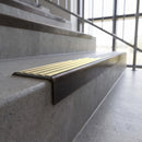 Solid brass stair nosing, 59.5mm tread with a 30mm square front, in Antique Bronze finish with Polished Brass insert, fitted to a staircase
