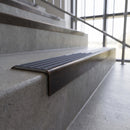 Solid brass stair nosing, 59.5mm tread with a 30mm square front, in Antique Bronze finish with Regency Castellated insert, fitted to a staircase