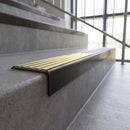Solid brass stair nosing, 59.5mm tread with a 30mm square front, in Antique Bronze finish with Satin Brass insert, fitted to a staircase