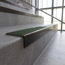 Solid brass stair nosing, 59.5mm tread with a 30mm square front, in Antique Bronze finish with Spruce Castellated insert, fitted to a staircase
