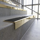 Solid brass stair nosing, 59.5mm tread with a 30mm square front, in Polished Brass finish with Black Smooth Textured insert, fitted to a staircase