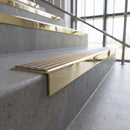 Solid brass stair nosing, 59.5mm tread with a 30mm square front, in Polished Brass finish with Fawn Castellated insert, fitted to a staircase