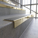 Solid brass stair nosing, 59.5mm tread with a 30mm square front, in Polished Brass finish with Flint Castellated insert, fitted to a staircase