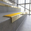Solid brass stair nosing, 59.5mm tread with a 30mm square front, in Polished Brass finish with Gold Castellated insert, fitted to a staircase