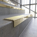 Solid brass stair nosing, 59.5mm tread with a 30mm square front, in Polished Brass finish with Ivory Castellated insert, fitted to a staircase