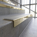 Solid brass stair nosing, 59.5mm tread with a 30mm square front, in Polished Brass finish with Light Grey Smooth Textured insert, fitted to a staircase
