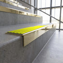 Solid brass stair nosing, 59.5mm tread with a 30mm square front, in Polished Brass finish with Yellow Castellated insert, fitted to a staircase