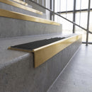 Solid brass stair nosing, 59.5mm tread with a 30mm square front, in Satin Brass finish with Black Smooth Textured insert, fitted to a staircase