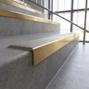 Solid brass stair nosing, 59.5mm tread with a 30mm square front, in Satin Brass finish with Light Grey Smooth Textured insert, fitted to a staircase