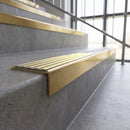 Solid brass stair nosing, 59.5mm tread with a 30mm square front, in Satin Brass finish with Polished Brass insert, fitted to a staircase