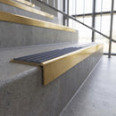 Solid brass stair nosing, 59.5mm tread with a 30mm square front, in Satin Brass finish with Regency Castellated insert, fitted to a staircase