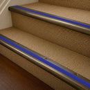 Antique Brass finish with Mid Blue Castellated insert - 63.5mm solid brass bullnose stair nosing fitted to a carpeted step