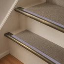 Antique Brass finish with Nimbus Castellated insert - 63.5mm solid brass bullnose stair nosing fitted to a carpeted step