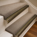 Antique Brass finish with Olive Castellated insert - 63.5mm solid brass bullnose stair nosing fitted to a carpeted step