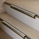 Antique Brass finish with Polar Grey Smooth Textured insert - 63.5mm solid brass bullnose stair nosing fitted to a carpeted step
