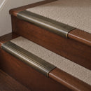 Antique Brass finish with Porth Stone Castellated insert - 63.5mm solid brass bullnose stair nosing fitted to a carpeted step