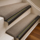 Antique Bronze finish with Olive Castellated insert - 63.5mm solid brass bullnose stair nosing fitted to a carpeted step