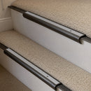 Antique Bronze finish with Polar Grey Smooth Textured insert - 63.5mm solid brass bullnose stair nosing fitted to a carpeted step
