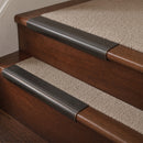 Antique Bronze finish with Porth Stone Castellated insert - 63.5mm solid brass bullnose stair nosing fitted to a carpeted step