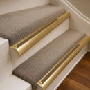 Satin Brass finish with Olive Castellated insert - 63.5mm solid brass bullnose stair nosing fitted to a carpeted step