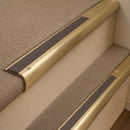 Satin Brass finish with Peat Castellated insert - 63.5mm solid brass bullnose stair nosing fitted to a carpeted step