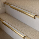 Satin Brass finish with Polar Grey Smooth Textured insert - 63.5mm solid brass bullnose stair nosing fitted to a carpeted step