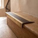 BN71SLR solid brass stair nosing in Antique Brass finish with Antique Bronze insert, fitted to a step edge
