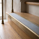 BN71SLR solid brass stair nosing in Antique Brass finish with Flint Castellated insert, fitted to a step edge