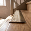 BN71SLR solid brass stair nosing in Antique Brass finish with Ivory Castellated insert, fitted to a step edge
