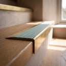 BN71SLR solid brass stair nosing in Antique Brass finish with Jade Castellated insert, fitted to a step edge