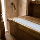 BN71SLR solid brass stair nosing in Antique Brass finish with Light Grey Smooth Textured insert, fitted to a step edge