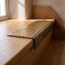 BN71SLR solid brass stair nosing in Antique Brass finish with Polished Brass insert, fitted to a step edge