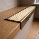 BN71SLR solid brass stair nosing in Antique Brass finish with Satin Brass insert, fitted to a step edge