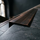BN71SLR solid brass stair nosing in Antique Bronze finish with Antique Bronze insert, fitted to a step edge