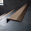 BN71SLR solid brass stair nosing in Antique Bronze finish with Fawn Castellated insert, fitted to a step edge