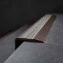 BN71SLR solid brass stair nosing in Antique Bronze finish with Flint Castellated insert, fitted to a step edge
