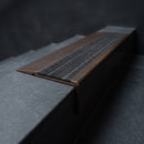 BN71SLR solid brass stair nosing in Antique Bronze finish with Granite Castellated insert, fitted to a step edge