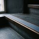 BN71SLR solid brass stair nosing in Antique Bronze finish with Mid Blue Castellated insert, fitted to a step edge