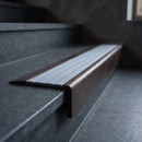 BN71SLR solid brass stair nosing in Antique Bronze finish with Nimbus Castellated insert, fitted to a step edge
