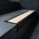 BN71SLR solid brass stair nosing in Antique Bronze finish with Porth Stone Smooth Textured insert, fitted to a step edge