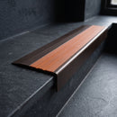 BN71SLR solid brass stair nosing in Antique Bronze finish with Rustic Castellated insert, fitted to a step edge