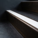 BN71SLR solid brass stair nosing in Antique Bronze finish with White Castellated insert, fitted to a step edge