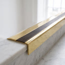 BN71SLR solid brass stair nosing in Polished Brass finish with Antique Bronze insert, fitted to a step edge