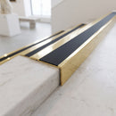 BN71SLR solid brass stair nosing in Polished Brass finish with Black Smooth Textured insert, fitted to a step edge