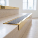 BN71SLR solid brass stair nosing in Polished Brass finish with Flint Castellated insert, fitted to a step edge