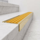 BN71SLR solid brass stair nosing in Polished Brass finish with Gold Castellated insert, fitted to a step edge